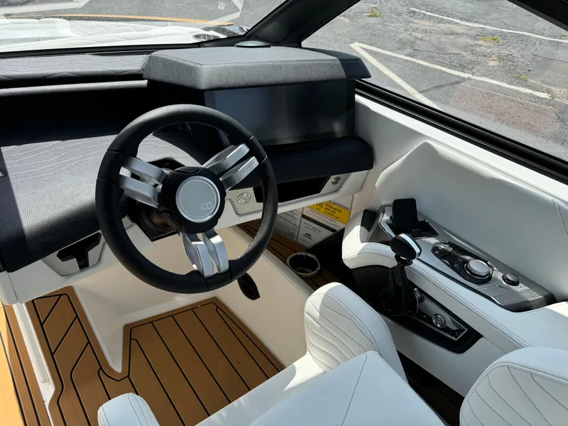 Slide: The Image of 2025 Nautique G23 boat interior with modern steering and controls. - 19