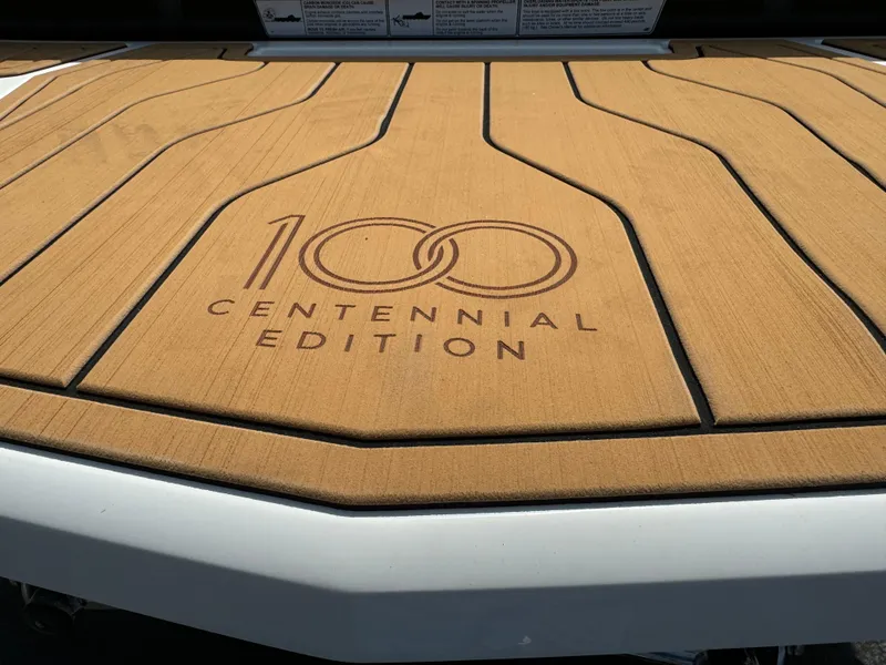 Slide: The Image of 2025 Nautique G23 Centennial Edition boat deck with logo. - 22