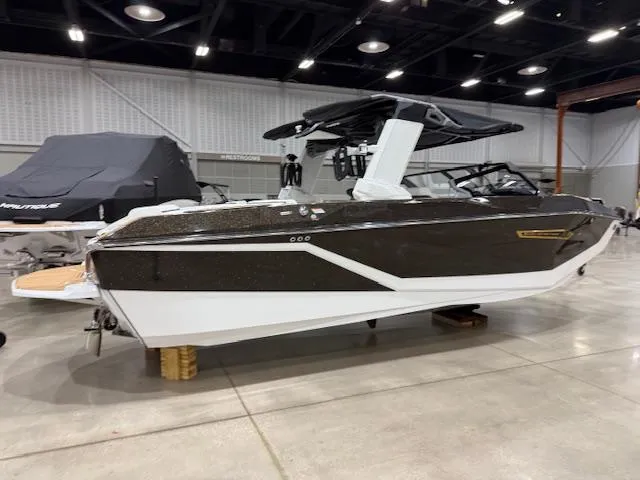 Slide: The Image of 2025 Nautique G23 boat displayed indoors, featuring sleek design and modern features. - 23