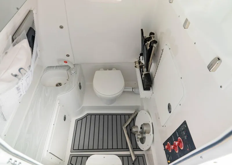 Slide: The Image of 2025 Sea Hunt Ultra 305 SE boat interior with toilet and sink. - 11