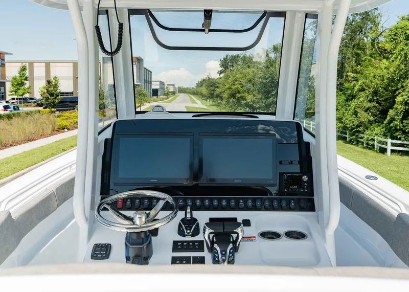 Slide: The Image of 2025 Sea Hunt Ultra 305 SE boat dashboard with modern navigation screens and controls. - 15