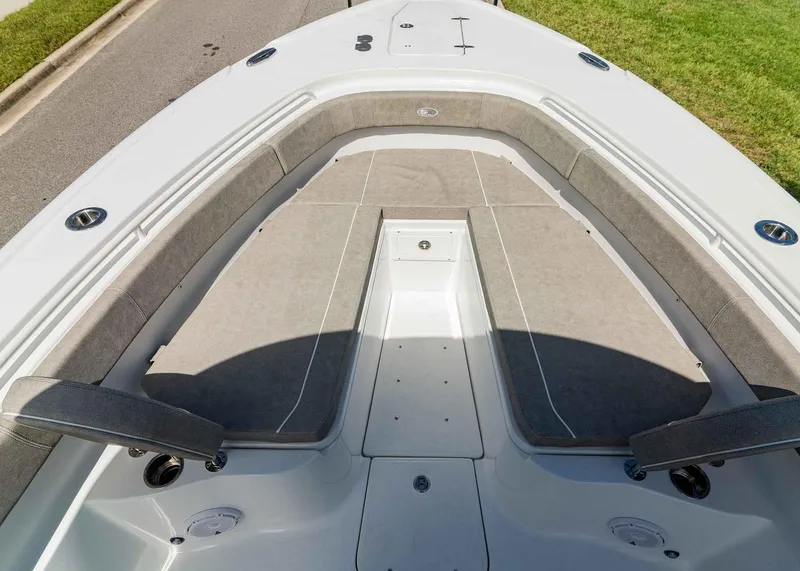 Slide: The Image of 2025 Sea Hunt Ultra 305 SE boat interior with cushioned seating and storage. - 16