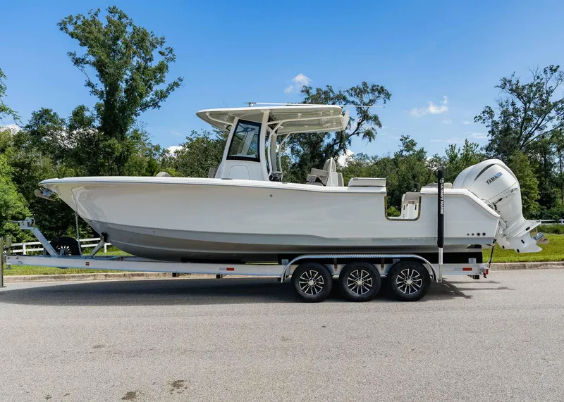 Slide: The Image of 2025 Sea Hunt Ultra 305 SE boat on trailer, parked outdoors. - 17