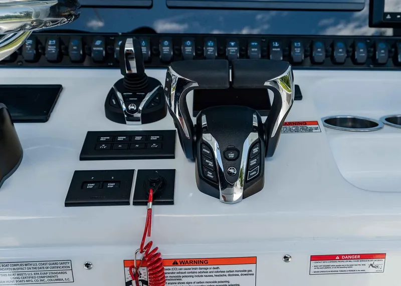Slide: The Image of Control panel of 2025 Sea Hunt Ultra 305 SE boat with throttle and switches. - 19