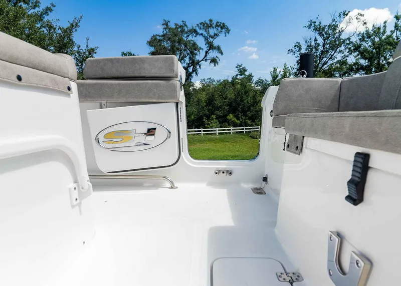 Slide: The Image of Interior view of 2025 Sea Hunt Ultra 305 SE boat with seating and logo. - 24