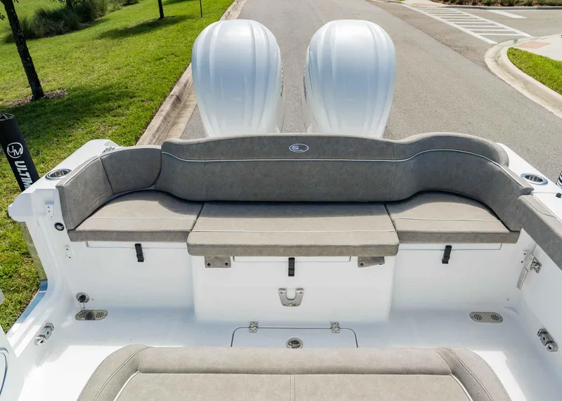 Slide: The Image of 2025 Sea Hunt Ultra 305 SE boat with dual engines and cushioned seating. - 25