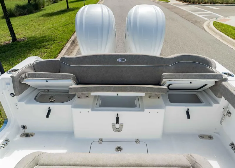 Slide: The Image of 2025 Sea Hunt Ultra 305 SE boat interior with dual engines and seating. - 26