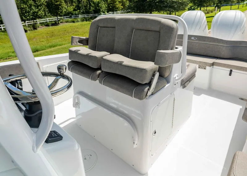 Slide: The Image of 2025 Sea Hunt Ultra 305 SE boat interior with dual seats and steering wheel. - 8
