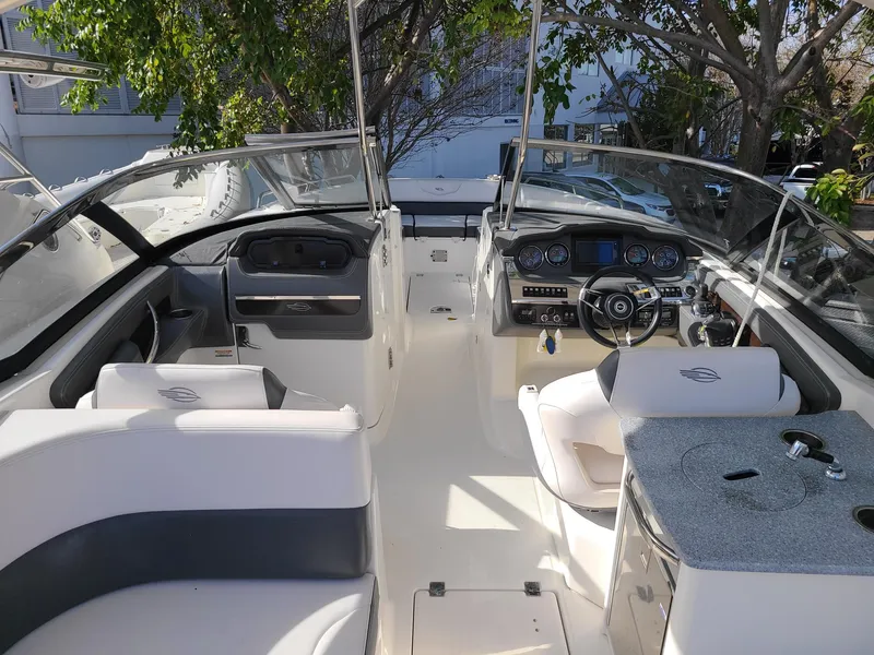 Slide: The Image of 2016 Chaparral 307 SSX boat interior with seating, steering wheel, and dashboard. - 10