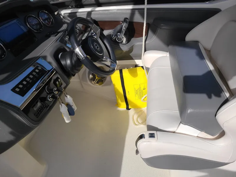 Slide: The Image of Interior of 2016 Chaparral 307 SSX boat showing steering wheel and dashboard controls. - 11