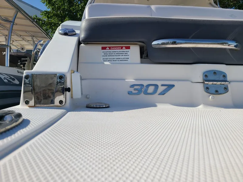 Slide: The Image of 2016 Chaparral 307 SSX boat deck with chrome details and model number. - 15