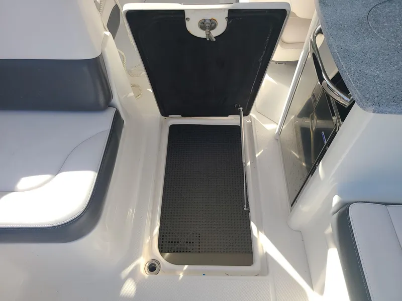 Slide: The Image of 2016 Chaparral 307 SSX boat interior with open storage compartment. - 17