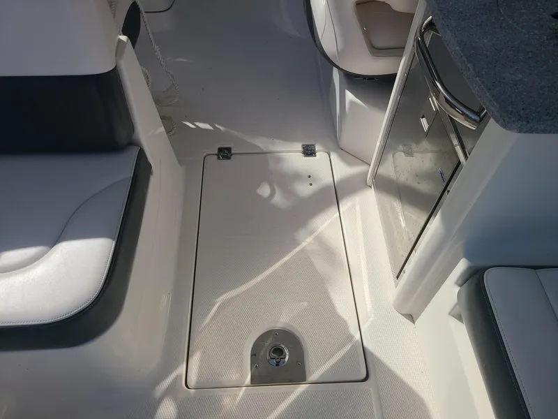 Slide: The Image of Interior view of 2016 Chaparral 307 SSX boat, featuring seating and storage area. - 18
