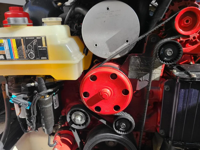 Slide: The Image of Engine components of a 2016 Chaparral 307 SSX boat, featuring belts and pulleys. - 23