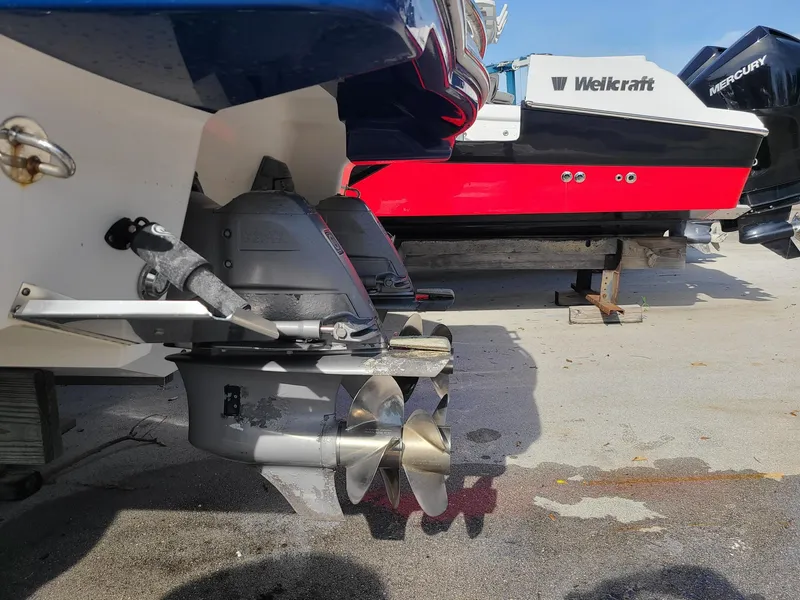 Slide: The Image of 2016 Chaparral 307 SSX boat propeller and stern, with another boat in the background. - 8