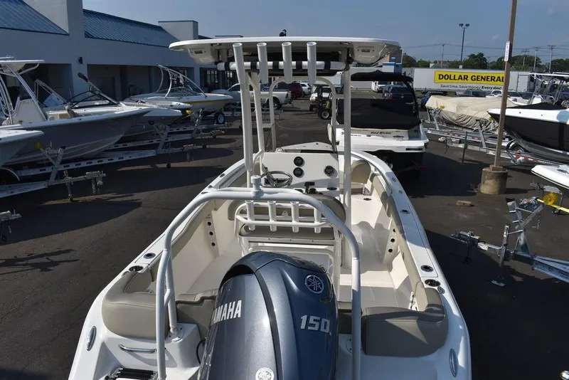 Slide: The Image of 2024 Key West 203 FS boat with Yamaha 150 engine, displayed at a dealership. - 10