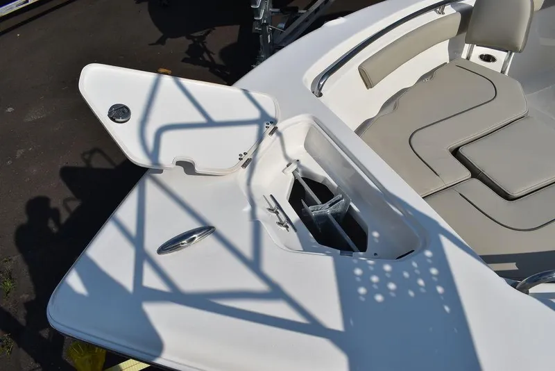 Slide: The Image of 2024 Key West 203 FS boat anchor compartment with open hatch and seating area. - 18