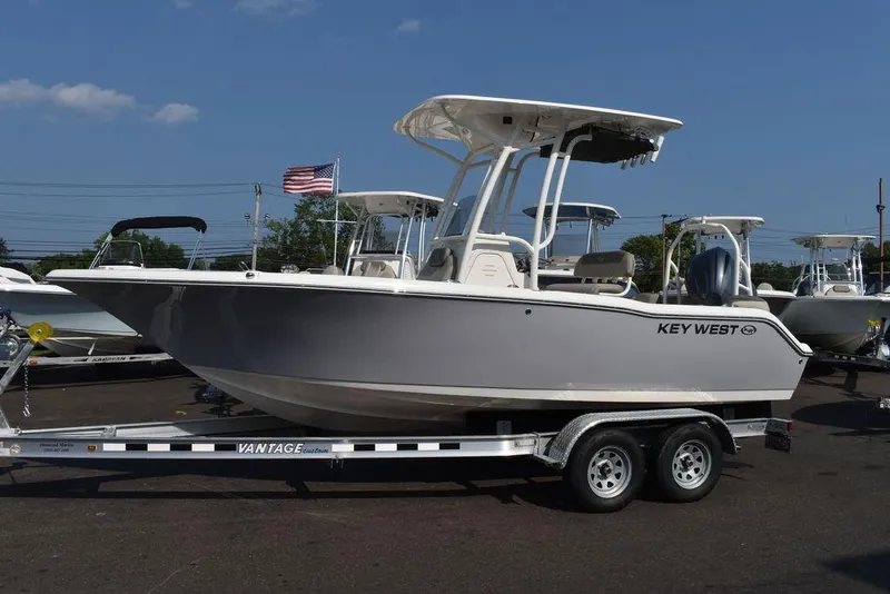 Slide: The Image of 2024 Key West 203 FS boat on trailer, displayed outdoors. - 2