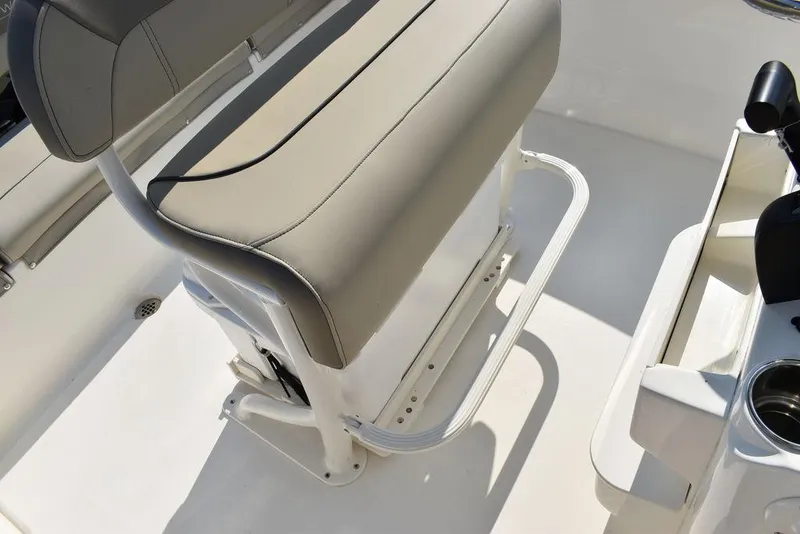 Slide: The Image of 2024 Key West 203 FS boat interior with cushioned seating and cup holders. - 32