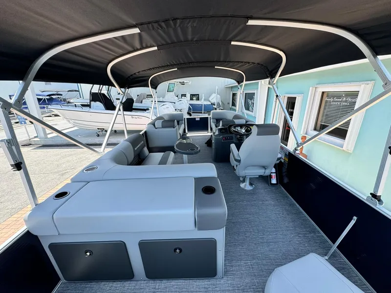 Slide: The Image of 2025 Bennington 22ss-sps pontoon boat interior with seating and canopy. - 10