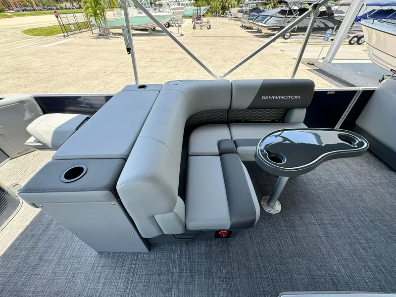 Slide: The Image of 2025 Bennington 22ss-sps pontoon boat interior with gray seating and table. - 14