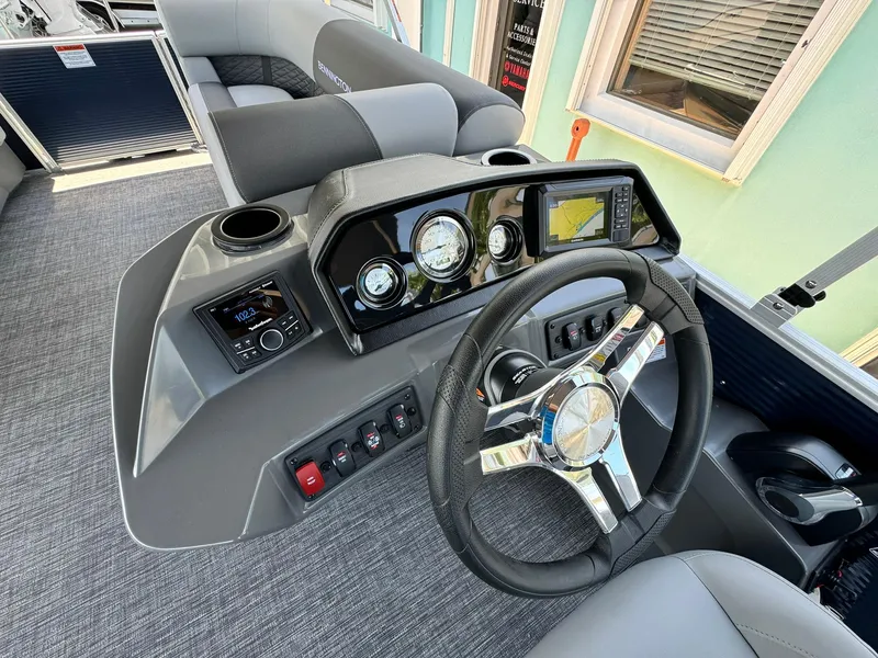 Slide: The Image of 2025 Bennington 22ss-sps boat dashboard with modern controls and steering wheel. - 17