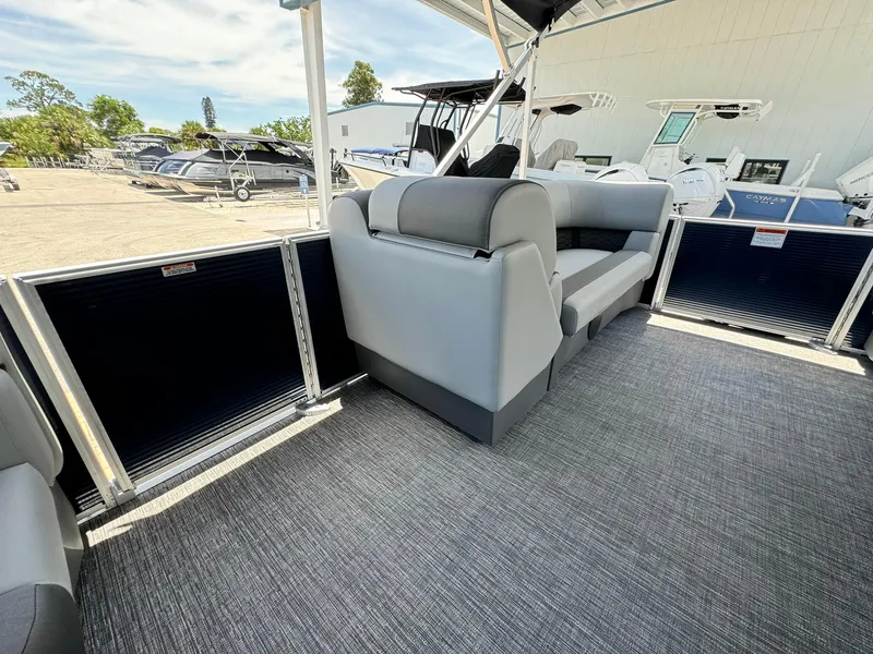 Slide: The Image of 2025 Bennington 22ss-sps pontoon boat interior with gray seating and carpeted flooring. - 19