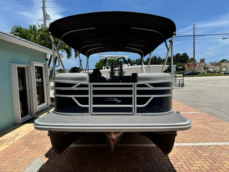 Slide: The Image of 2025 Bennington 22ss-sps pontoon boat parked on brick pavement. - 2