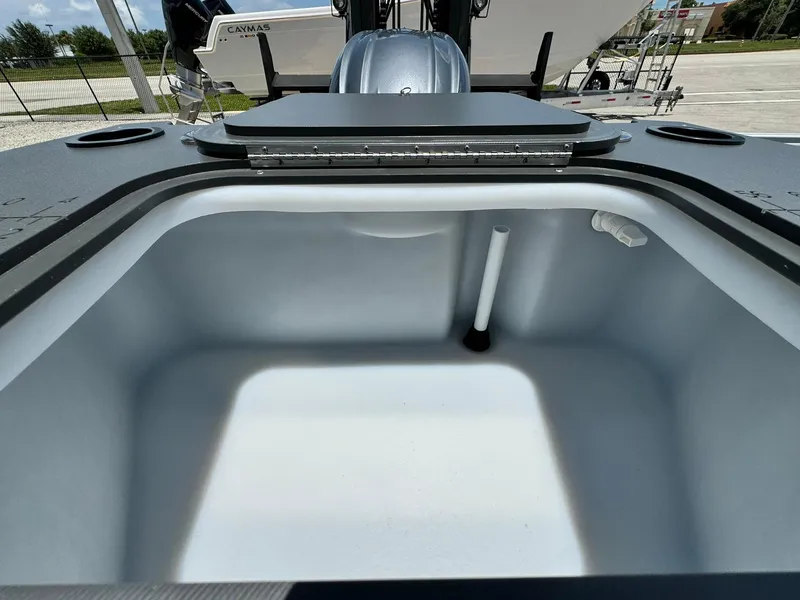 Slide: The Image of 2025 Bennington 22ss-sps boat storage compartment, open and empty, with a sleek design. - 9