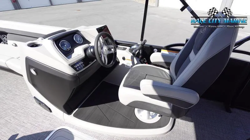 Slide: The Image of 2025 Barletta C24UC boat interior with steering wheel and captain's chair. - 11