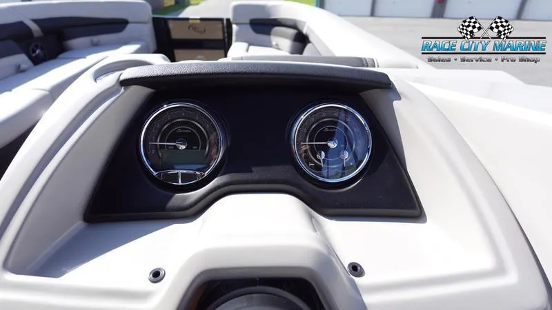 Slide: The Image of Dashboard of 2025 Barletta C24UC boat with dual gauges, Race City Marine logo. - 15