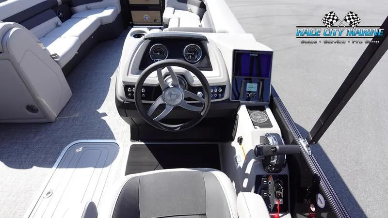 Slide: The Image of 2025 Barletta C24UC boat cockpit with steering wheel and control panel. - 18