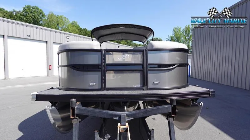 Slide: The Image of 2025 Barletta C24UC pontoon boat at Race City Marine dealership. - 2