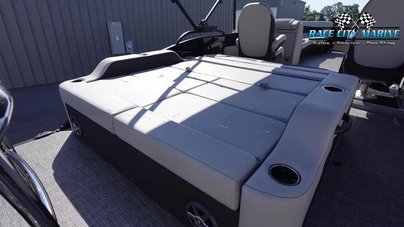 Slide: The Image of 2025 Barletta C24UC boat interior with cushioned seating and cup holders. - 21