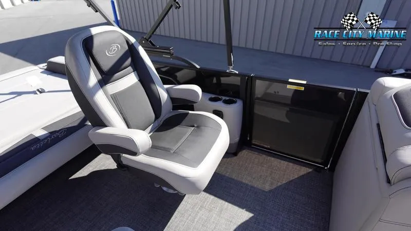 Slide: The Image of Barletta C24UC 2025 boat interior with captain's chair and cup holders. - 32