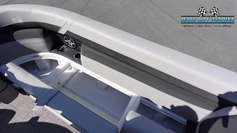 Slide: The Image of 2025 Barletta C24UC boat interior with storage compartments and cup holders. - 33