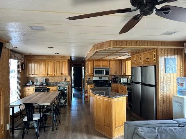 Slide: The Image of Spacious kitchen in a 1994 Lakeview model 1666, featuring wooden cabinets and modern appliances. - 3