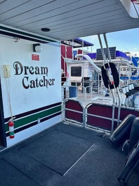 Slide: The Image of Houseboat "Dream Catcher" docked, Lakeview 1666 model, 1994, with safety equipment visible. - 6