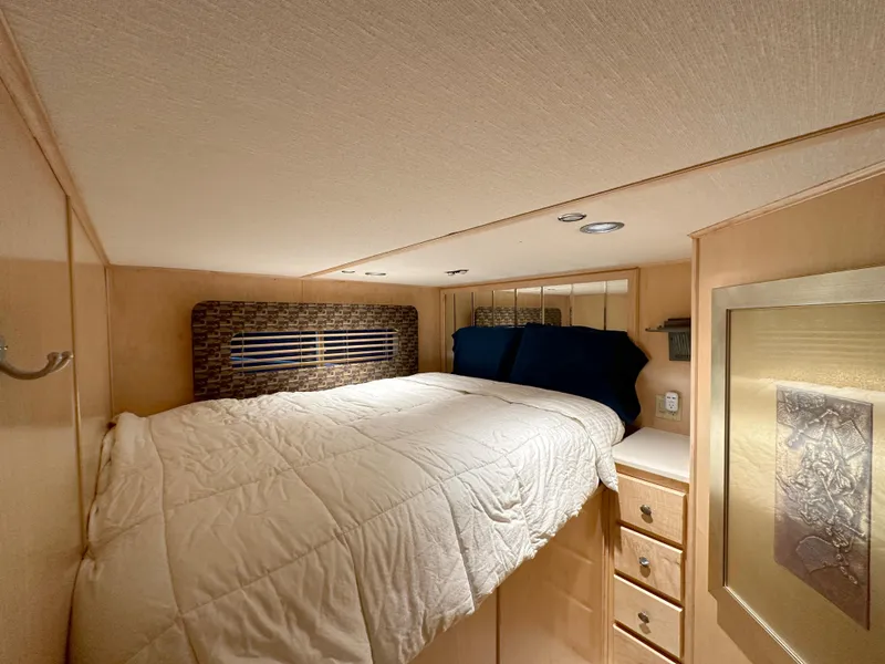 Slide: The Image of Cozy bedroom in 2001 Custom Endless Summer RV with modern decor and storage. - 10