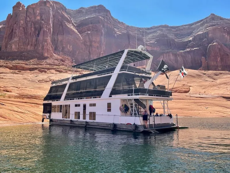 Slide: The Image of Houseboat "Endless Summer" on serene lake, surrounded by rocky cliffs, under clear blue sky. - 12