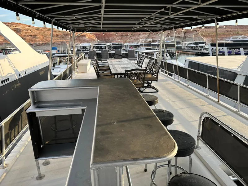 Slide: The Image of Spacious upper deck of 2001 Custom Endless Summer yacht with bar and seating area. - 14