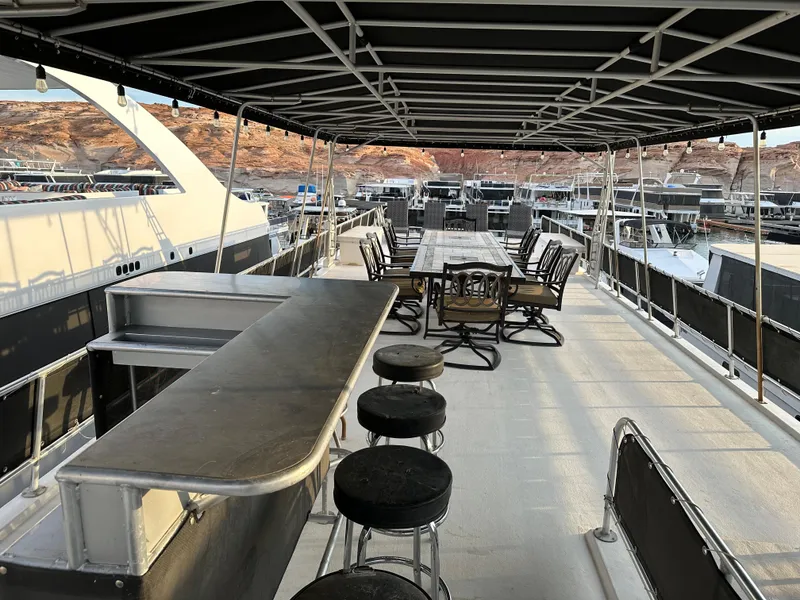 Slide: The Image of Spacious deck of 2001 Custom Endless Summer houseboat with bar and seating area. - 15