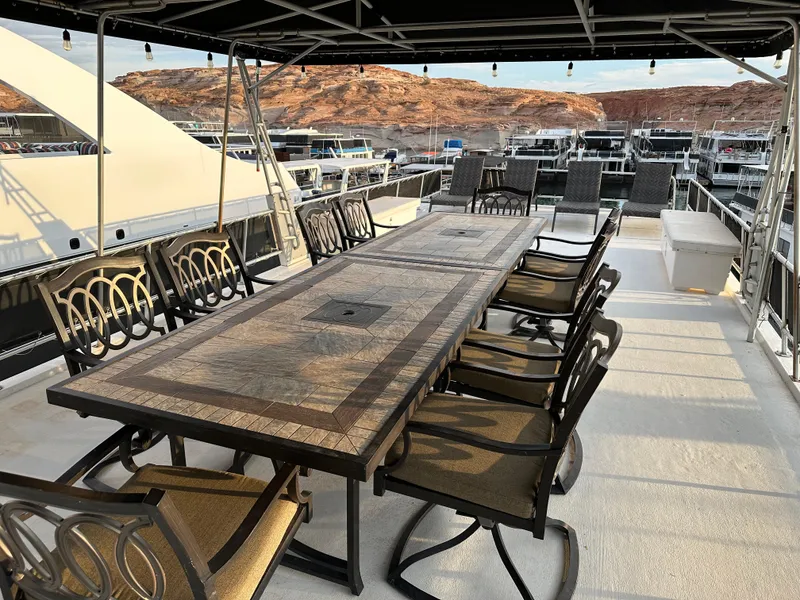 Slide: The Image of Spacious deck on 2001 Custom Endless Summer yacht with elegant dining setup. - 16