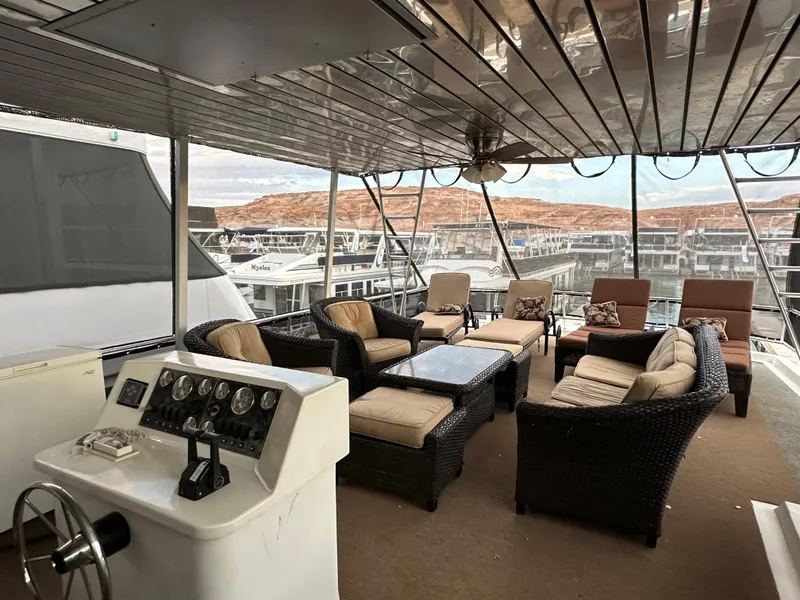Slide: The Image of Luxurious 2001 Custom Endless Summer yacht interior with wicker seating and scenic marina view. - 19