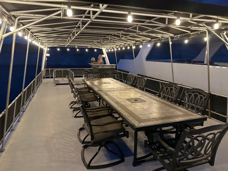 Slide: The Image of Spacious deck on 2001 Custom Endless Summer yacht with dining table and string lights. - 20