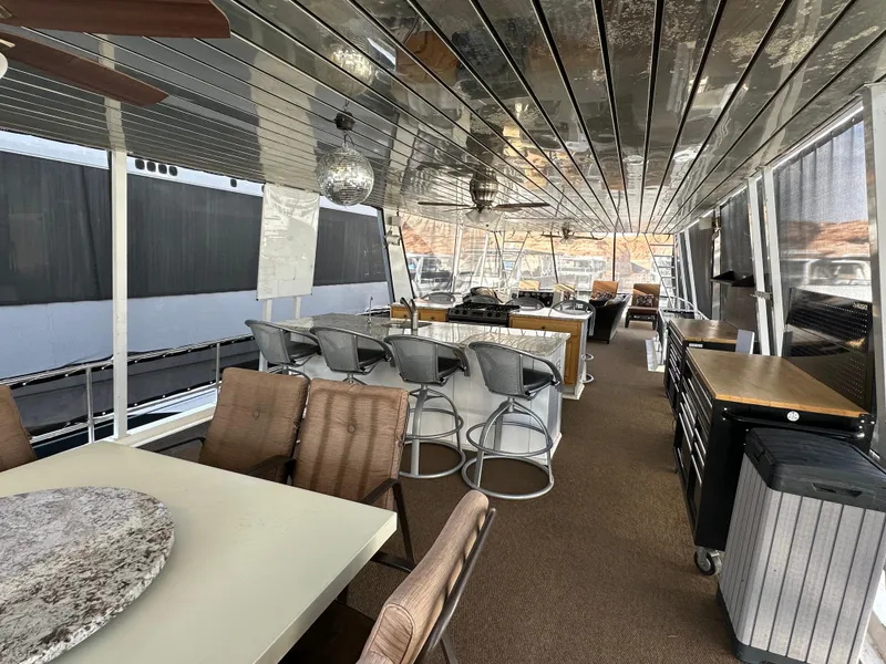 Slide: The Image of Luxurious interior of 2001 Custom Endless Summer houseboat with modern seating and dining area. - 28