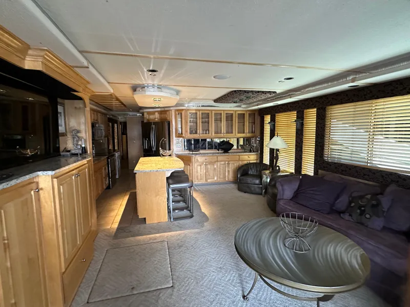 Slide: The Image of Luxurious 2001 Custom Endless Summer RV interior with modern kitchen and cozy living area. - 31