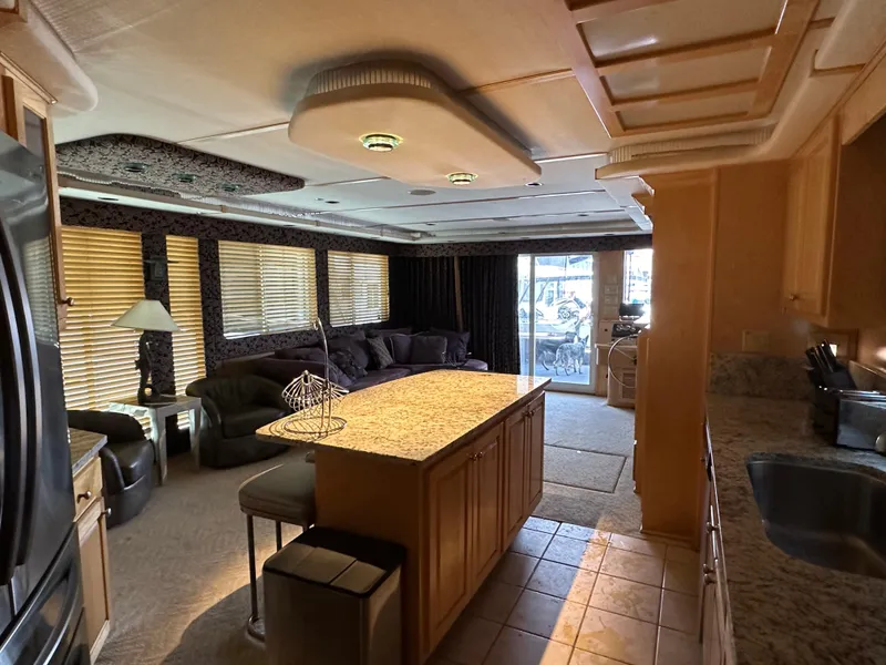 Slide: The Image of Luxurious 2001 Custom Endless Summer RV interior with kitchen island and cozy seating area. - 35