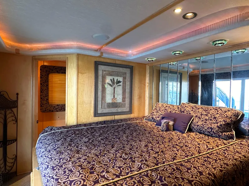 Slide: The Image of Luxurious bedroom in 2001 Custom Endless Summer RV with elegant decor and ambient lighting. - 36