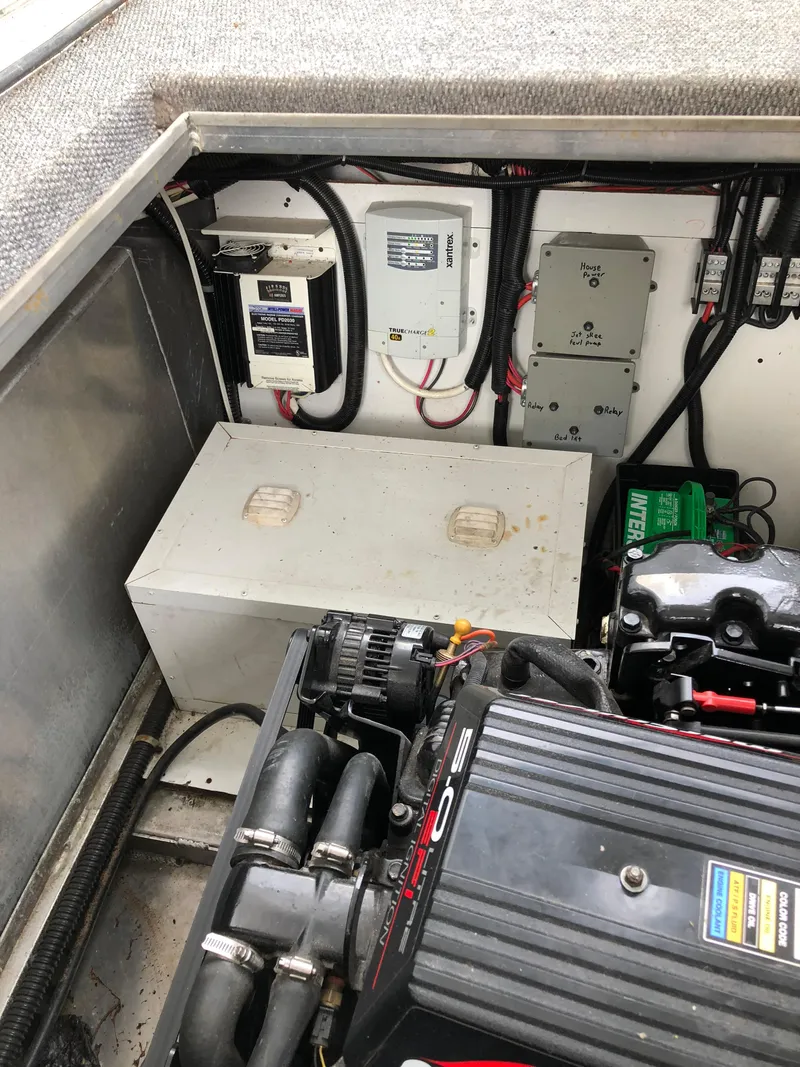 Slide: The Image of Engine compartment of 2001 Custom Endless Summer boat with visible wiring and components. - 4